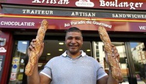 parisian-baker-ridha-khadher-winner-of-the-best-baguette-of-paris-2013-award-poses-in-front-of-his-bakery-after-the-verdict-in-paris